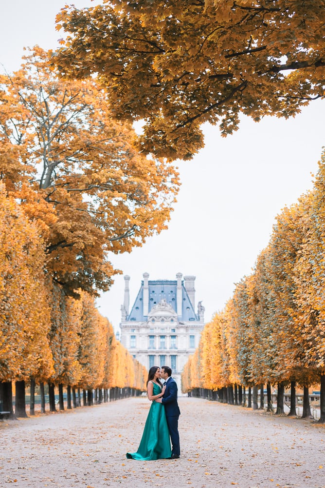 Fall engagement photos in Paris - Newly engaged couple kissing in autumn in the Tuileries gardens in Paris France Fall engagement photos in Paris - Newly engaged couple kissing in autumn in the Tuileries gardens in Paris France