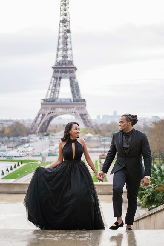 Cute couple photo shoot - couple having romantic stroll in Paris in front of the Eiffel Tower Cute couple photo shoot - couple having romantic stroll in Paris in front of the Eiffel Tower