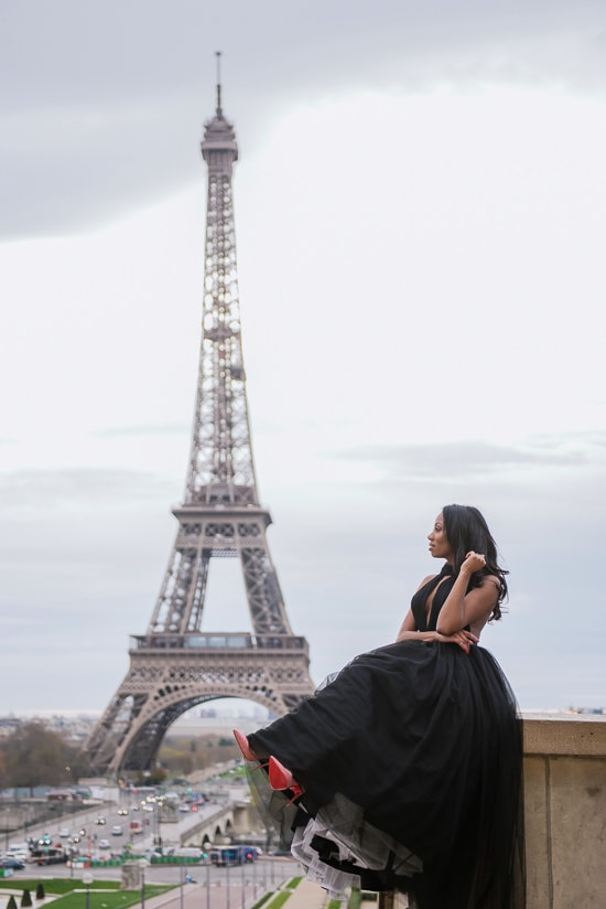 Cute girl wearing Louboutin stilettos posing in front of the Eiffel Tower Cute girl wearing Louboutin stilettos posing in front of the Eiffel Tower