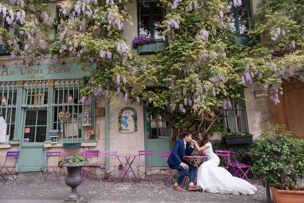 Paris photographer knows hiddel places in the city. Asian groom kissing bride's hand at Au Vieux Paris Paris photographer knows hiddel places in the city. Asian groom kissing bride's hand at Au Vieux Paris
