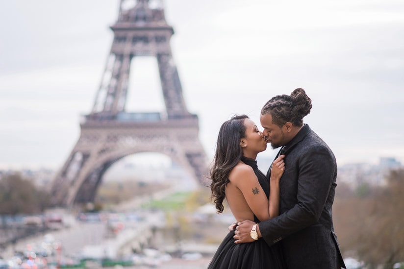 Young couple having a romantic kiss in Paris in front of the Eiffel Tower Young couple having a romantic kiss in Paris in front of the Eiffel Tower